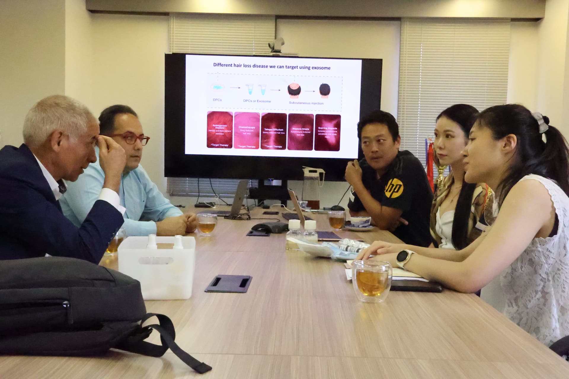 A joint technical session on exosome applications in hair biology, with research partners reviewing target indications together.