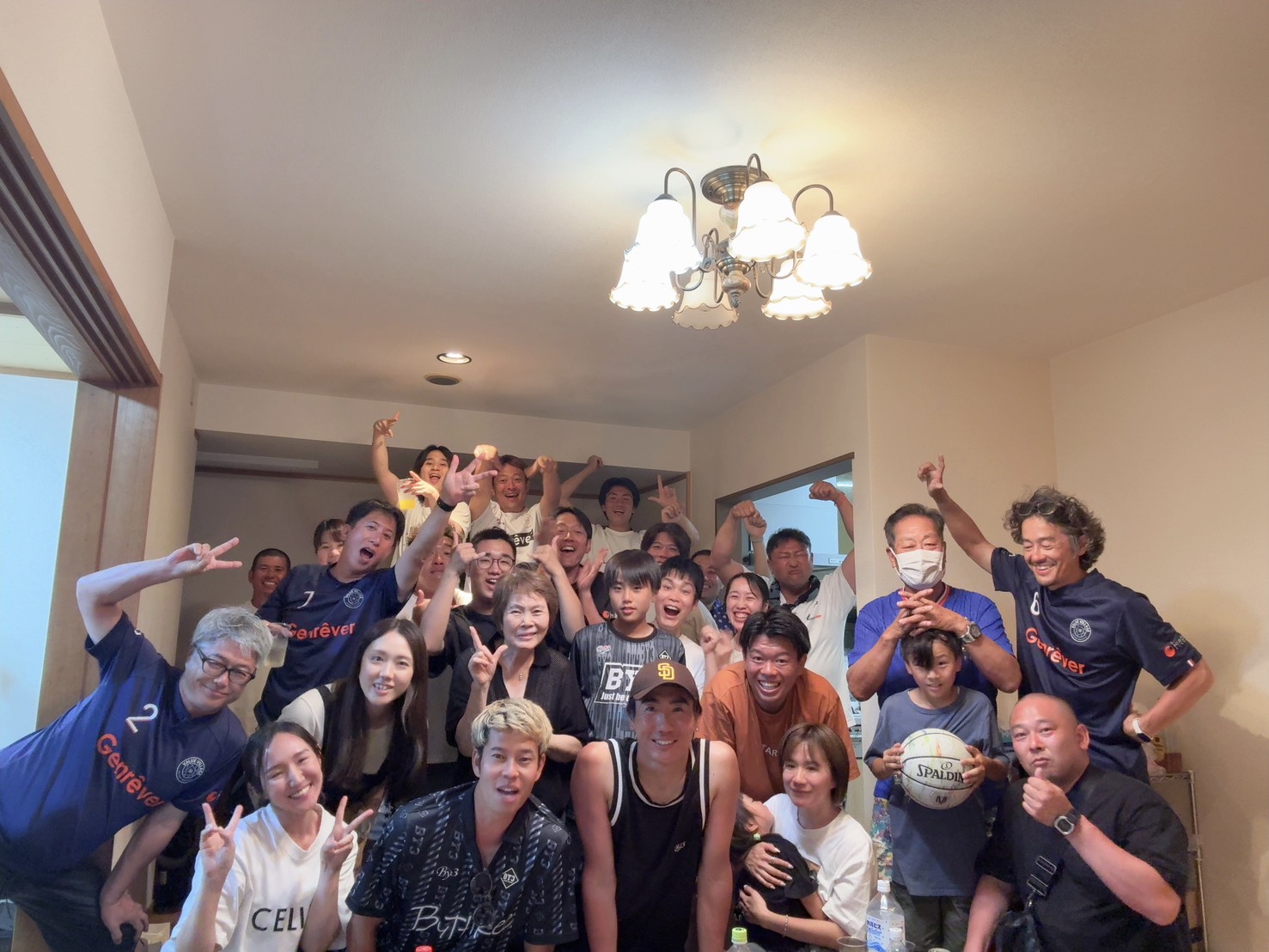 Players, families and staff celebrating together after a Genrêver FC match.