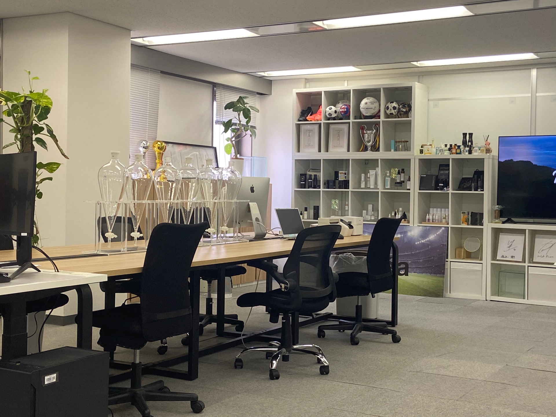 The Tokyo office floor, with laboratory glassware and the product showroom shelf.