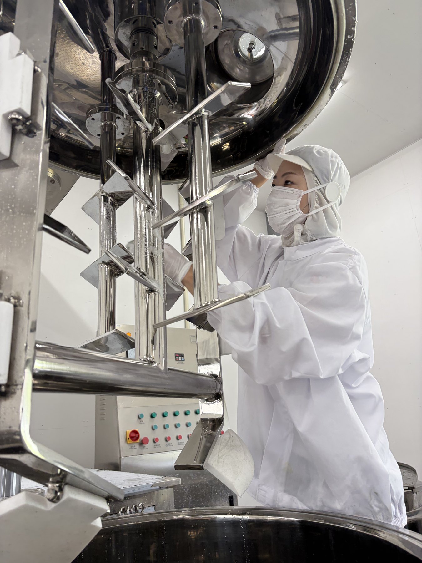 Setting up the emulsifying mixer before a production run.